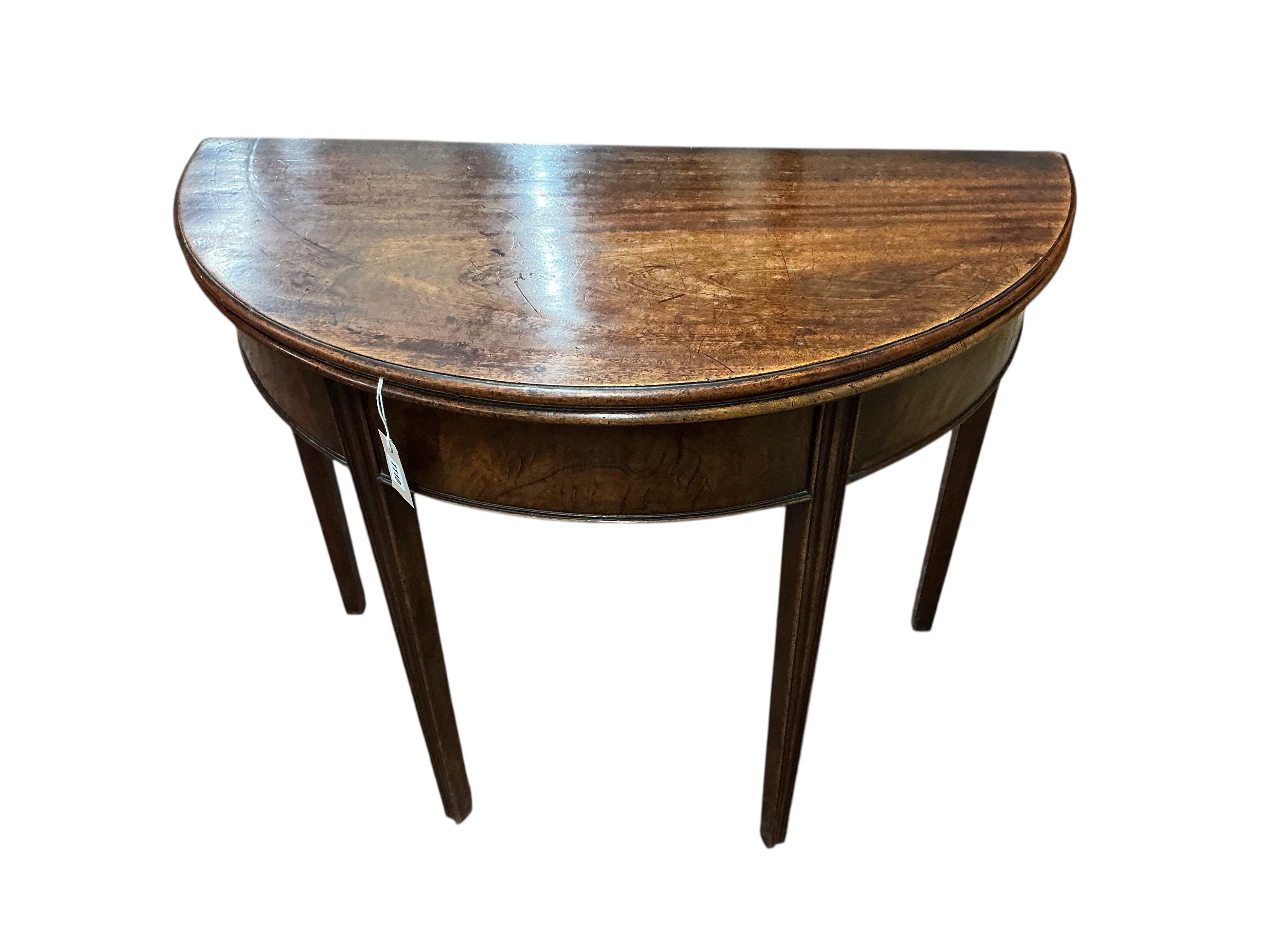 A George III mahogany demi lune folding tea table, width 93cm, depth 46cm, height 74cm